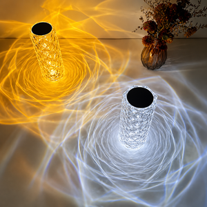 Two crystal LED table lamps projecting warm and cool light patterns