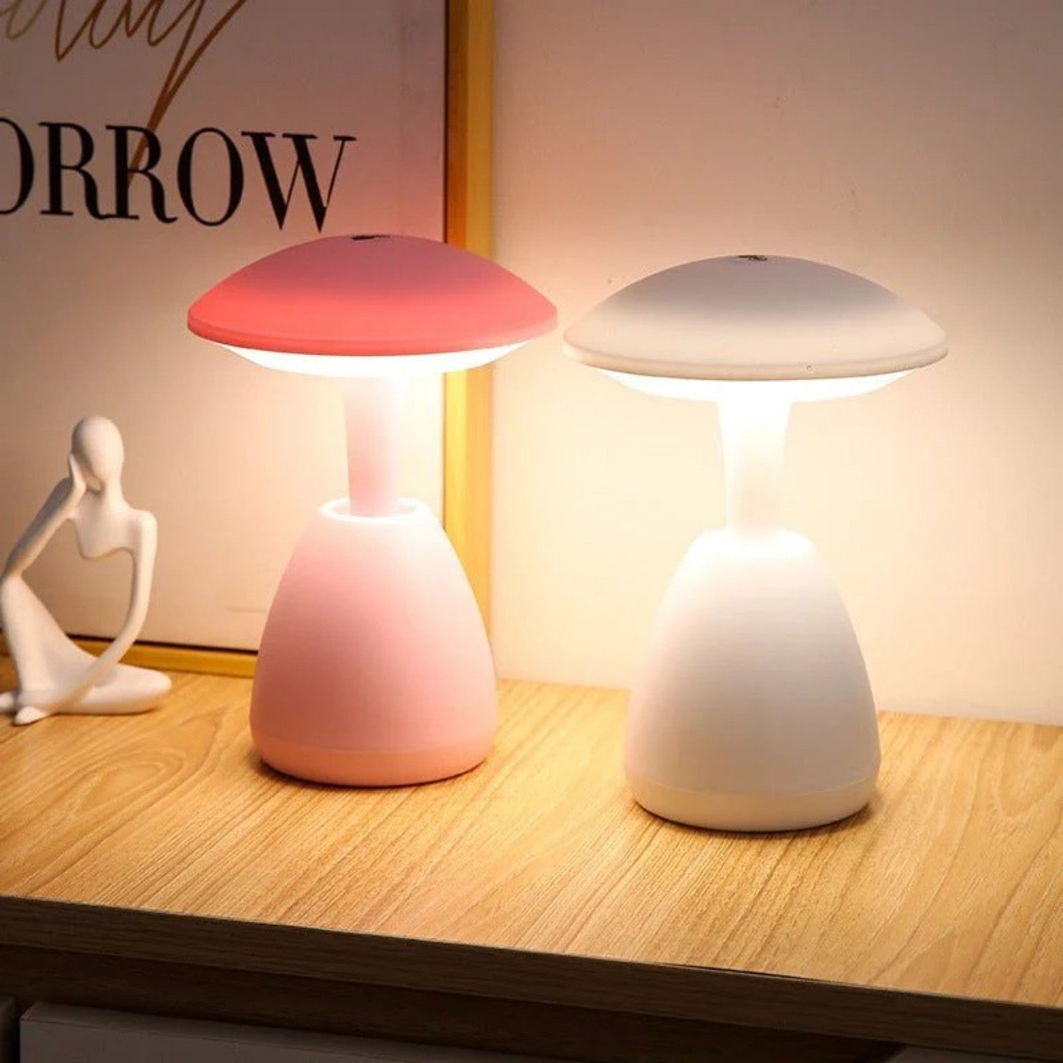 Pink and white mushroom LED night lamps glowing on bedside table